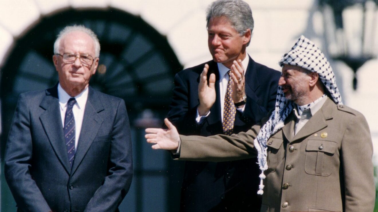 De gauche à droite : le Premier ministre israélien Yitzhak Rabin, le président américain Bill Clinton et le leader de l’OLP Yasser Arafat après la signature de l’accord d'Oslo 1993. On notera l’empressement d’Yitzhak Rabin à serrer la main de Yasser Arafat.